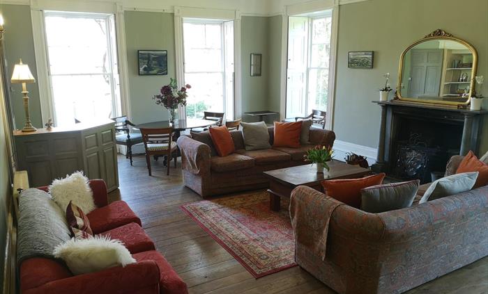 Our spacious Drawing Room has its own bar that you can stock with whatever you may wish, an open coal fire and comfy sofas to sit back and relax on. T